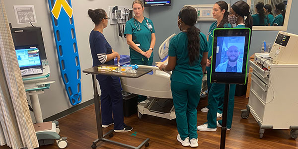 Nursing students train with telehealth robots.